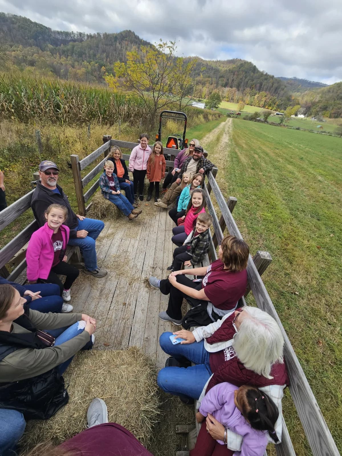 Students and teachers on a hayride through scenic West Virginia farmland