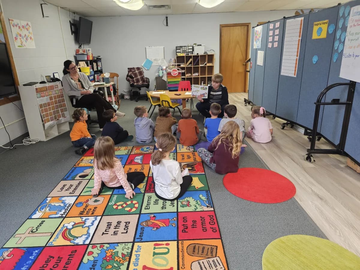 Young students gathered on a colorful carpet during circle time in the classroom