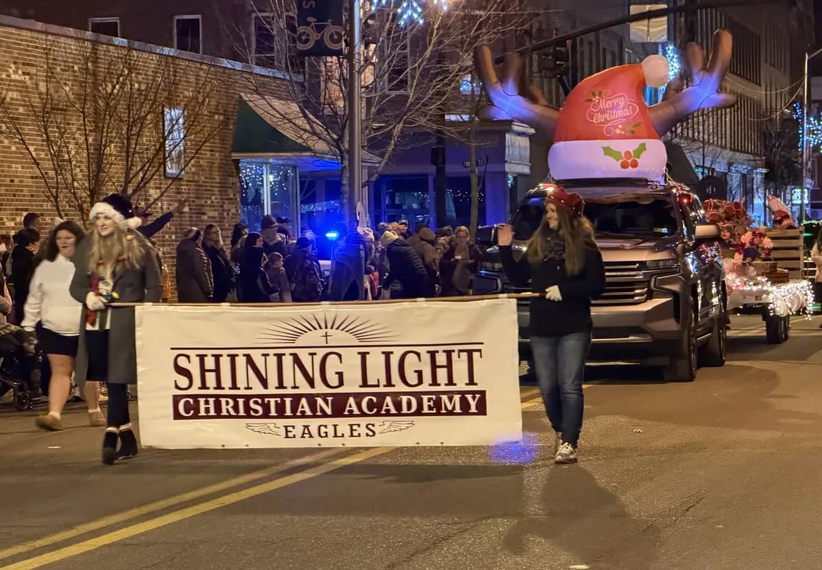 Students carrying the school banner during the Christmas parade