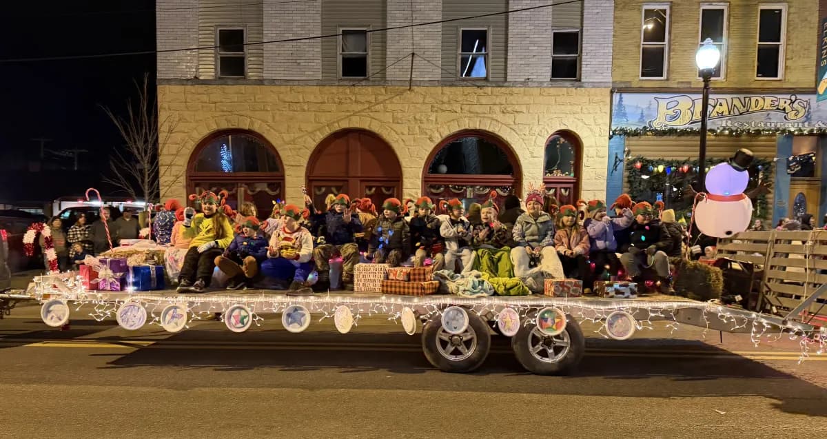 Students and families on the decorated Christmas parade float