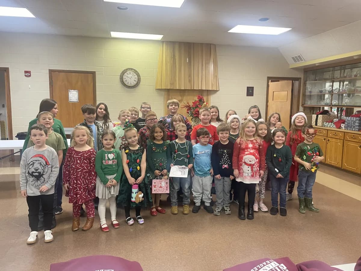 Students wearing Christmas sweaters and festive attire for the Christmas party